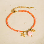 burnt orange beaded bracelet with seashell charms