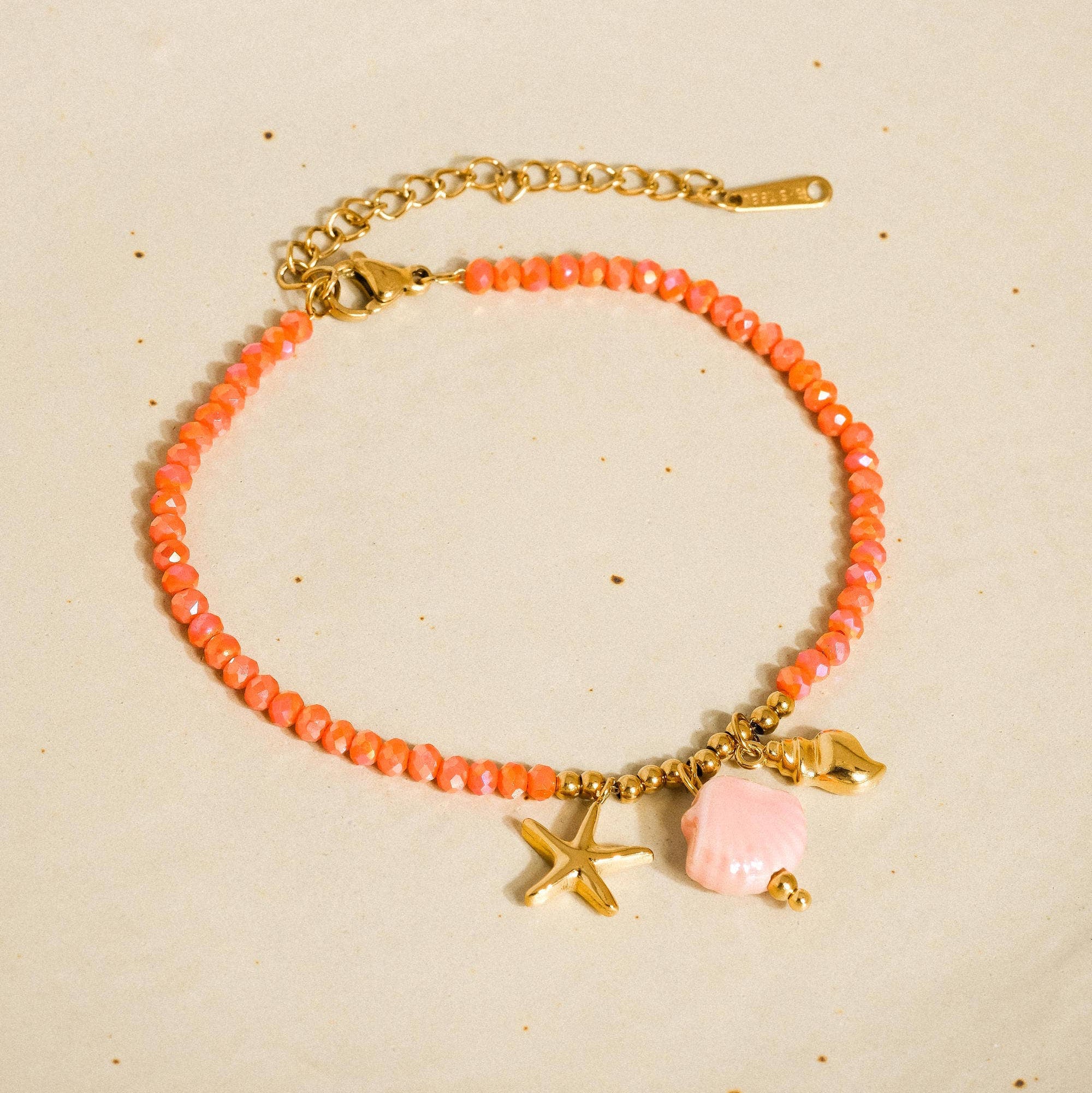 burnt orange beaded bracelet with seashell charms