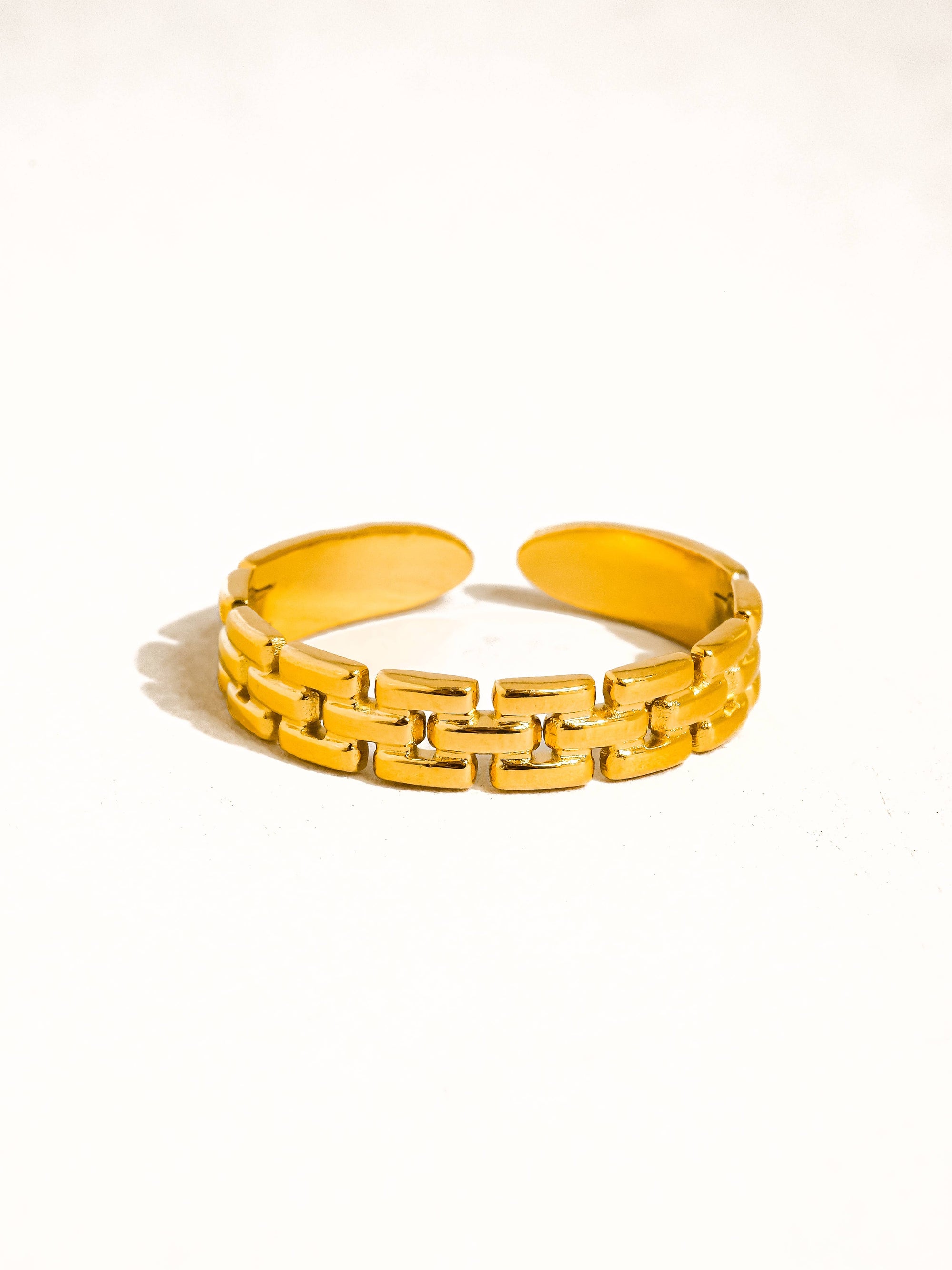 Yellow chain-link bracelet on a white background