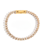 Bracelet with gold and clear beads on a white background