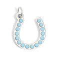 Silver horseshoe charm with turquoise stones on a white background
